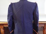 a mannequin sitting on a table with a suit on it