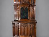 an old wooden cabinet with a mirror on top of it