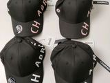 four black caps with white letters on them sitting on top of a table