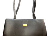 black leather handbag with a yellow handle on a white background