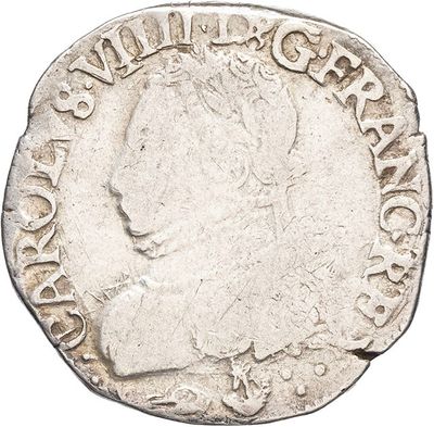 a silver coin with the head of a man on it