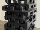 a stack of black plastic pallets stacked on top of each other