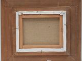 a close up of a picture frame with a piece of paper taped around it