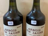 two bottles of wine sitting on top of a wooden table