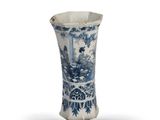 an old blue and white vase with a man in a boat on the water