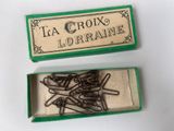 a small box with a bunch of pins in it