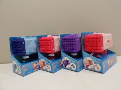four different colors of toothbrushes in a box on a table