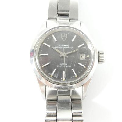 a close up of a wrist watch on a white surface