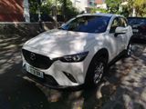 the mazda cx - 3 is parked on the side of the street