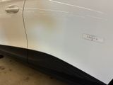 a close up of a white car with a sticker on it