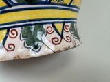 a close up of a vase on a wall
