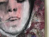 a painting of a woman ' s face on the wall