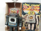 a toy robot that is sitting next to a box
