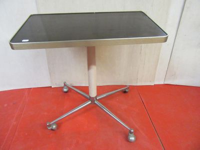 a small table with a glass top on a red floor