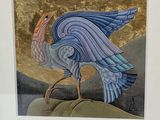 a picture of a bird that is standing on a rock