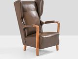 an image of a brown leather chair with a wooden frame