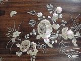a wooden tray with flowers on it on a table