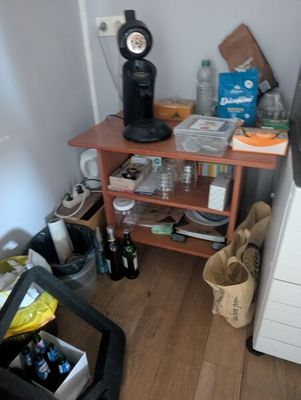 a small kitchen with a coffee maker on a small table