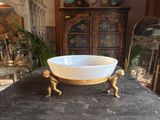 a white bowl sitting on top of a wooden table
