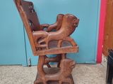 a wooden high chair with a dog on it