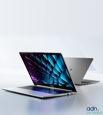 two laptops side by side on a white surface with a blue and purple background