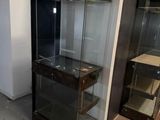 a glass display case in the corner of a room