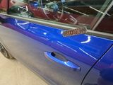 a blue car with a sticker on the side of it