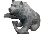 a statue of a bear that is sitting on its hind legs