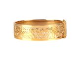 a close up of a gold bracelet on a white background