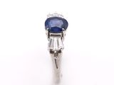 a close up of a blue sapphire and diamond ring on a white background