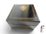 a black box with a gold emblem on it