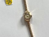 a small watch that is on a white table