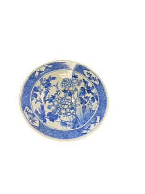 a blue and white plate with flowers on it