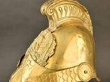 an image of a gold helmet with a crest on it