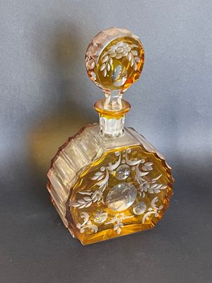 yellow glass perfume bottle with a floral design on the top