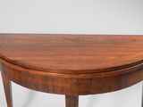 a close up of a wooden table with a curved top