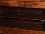 a wooden cabinet with a mirror on top of it