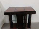 a wooden table with two shelves on each side of it