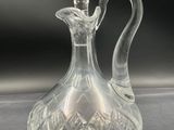 an image of a clear glass decanter on a table
