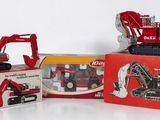 three toy trucks and a toy truck in a box