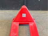 a close up of a fork lifter on a concrete floor