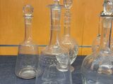 three clear glass decanters sitting on top of a blue table