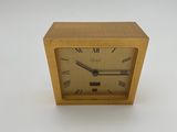 an image of a gold clock with roman numerals on the face