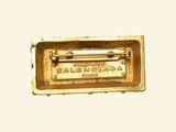 a gold plate with a nameplate on it