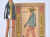 a figurine of a man standing next to a box of cigarettes