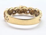 a close up of a gold ring on a white surface