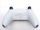 a close up of a white controller on a white surface