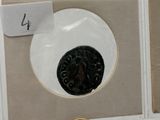 four plates with numbers on them on display in a box
