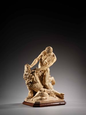 a carved ivory figurine of a man and a dog