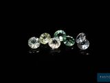 a group of three different colored diamonds on a black surface